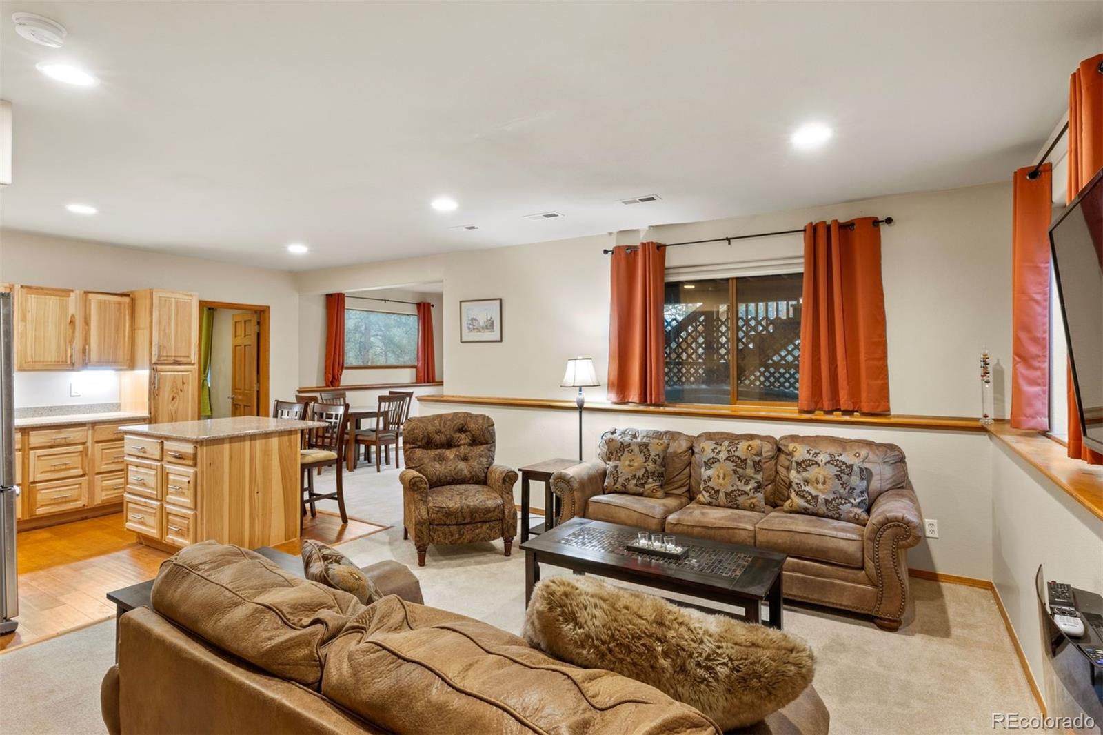 3154 South Piney Ridge Road Evergreen, CO 80439 - Photo 31 of 49 a living room with furniture and large windows