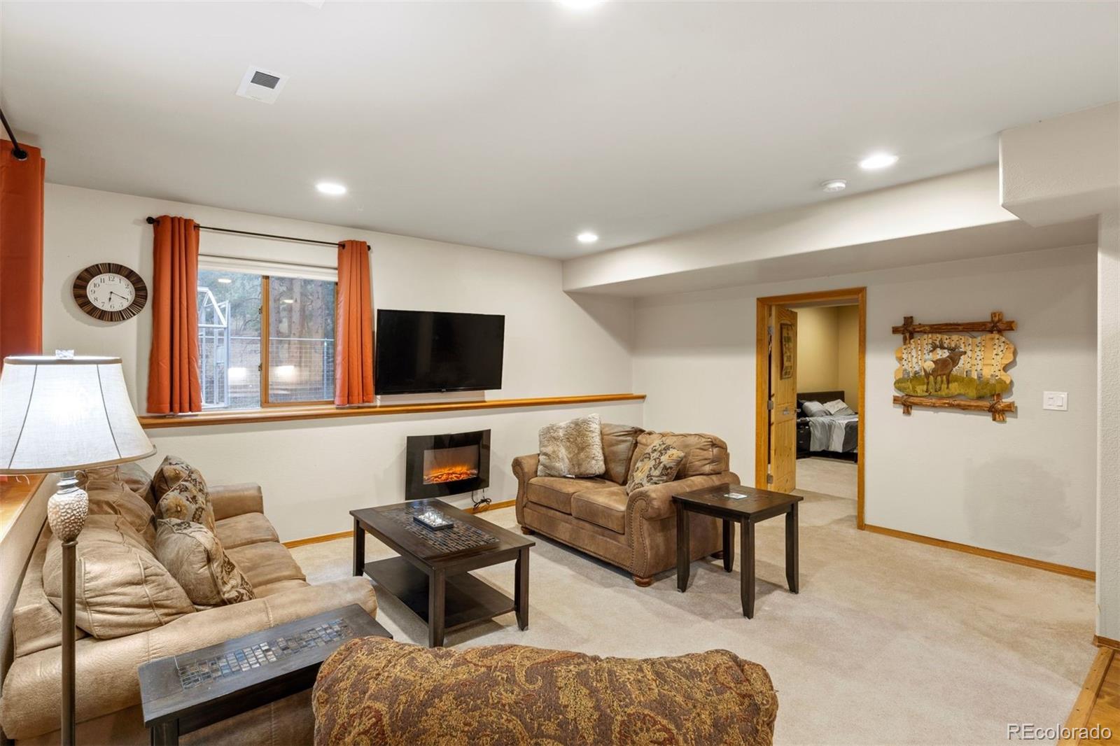 3154 South Piney Ridge Road Evergreen, CO 80439 - Photo 32 of 49 a living room with furniture and a flat screen tv