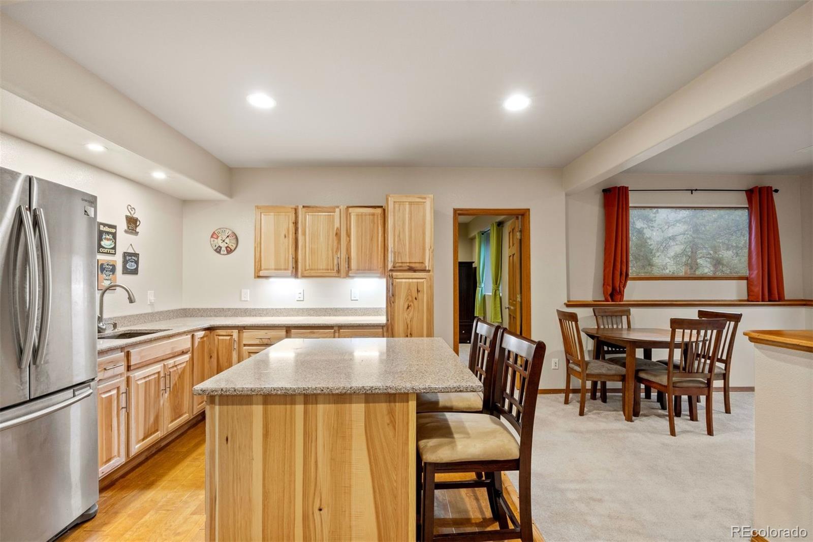 3154 South Piney Ridge Road Evergreen, CO 80439 - Photo 33 of 49 a kitchen with stainless steel appliances granite countertop a dining table chairs and granite counter tops