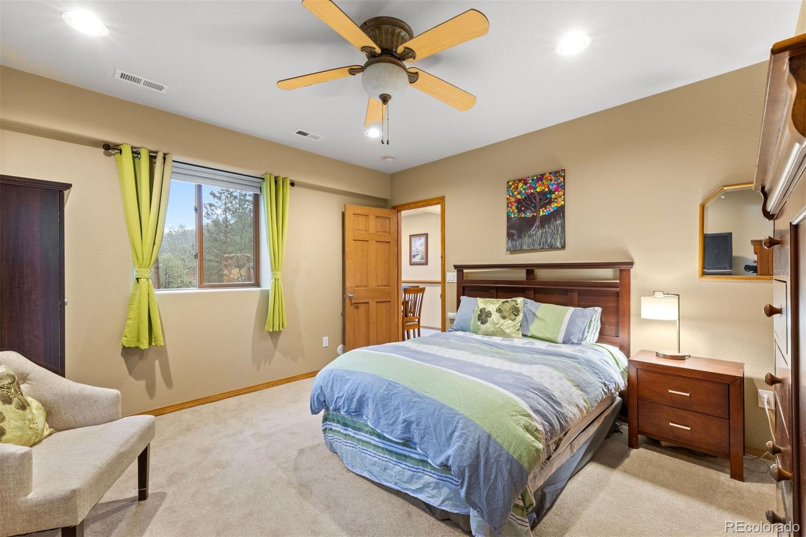 3154 South Piney Ridge Road Evergreen, CO 80439 - Photo 35 of 49 a bedroom with a bed and wooden floor