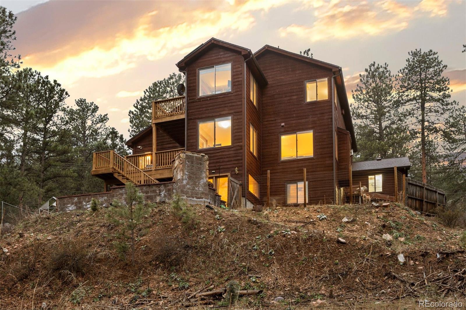 3154 South Piney Ridge Road Evergreen, CO 80439 - Photo 40 of 49 a front view of a house with garden