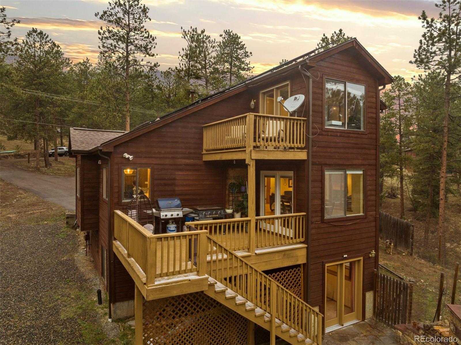 3154 South Piney Ridge Road Evergreen, CO 80439 - Photo 41 of 49 a front view of a house with balcony
