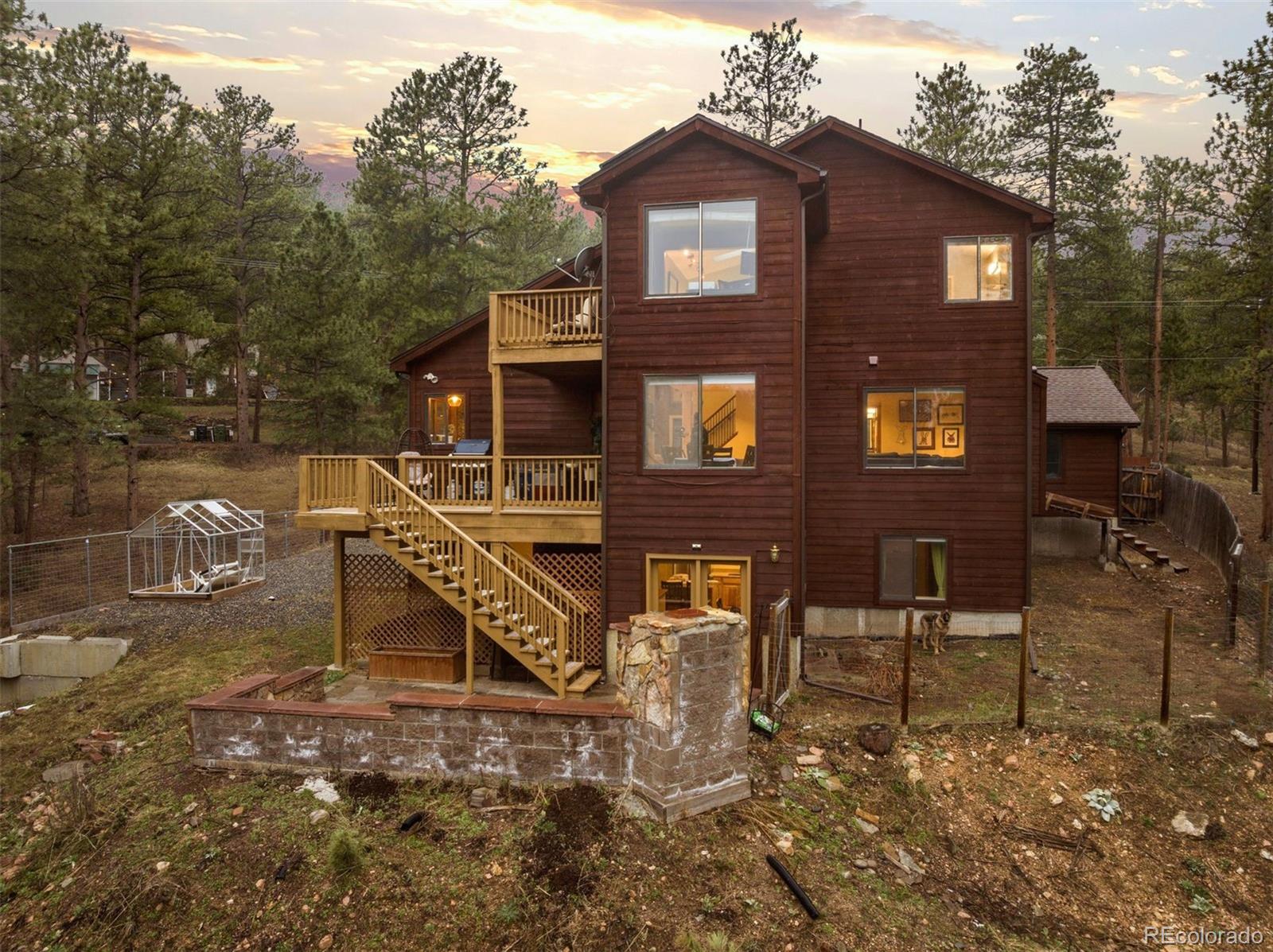 3154 South Piney Ridge Road Evergreen, CO 80439 - Photo 42 of 49 a front view of a house with a yard