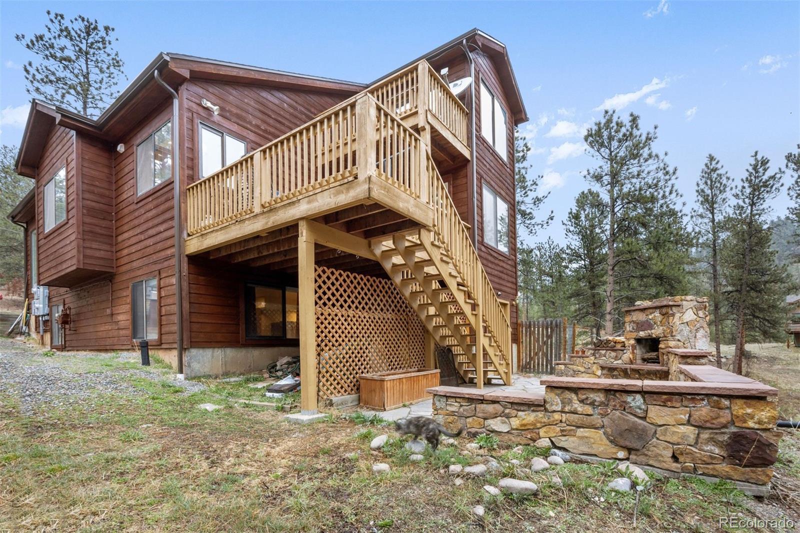 3154 South Piney Ridge Road Evergreen, CO 80439 - Photo 46 of 49 a view of a house with a yard