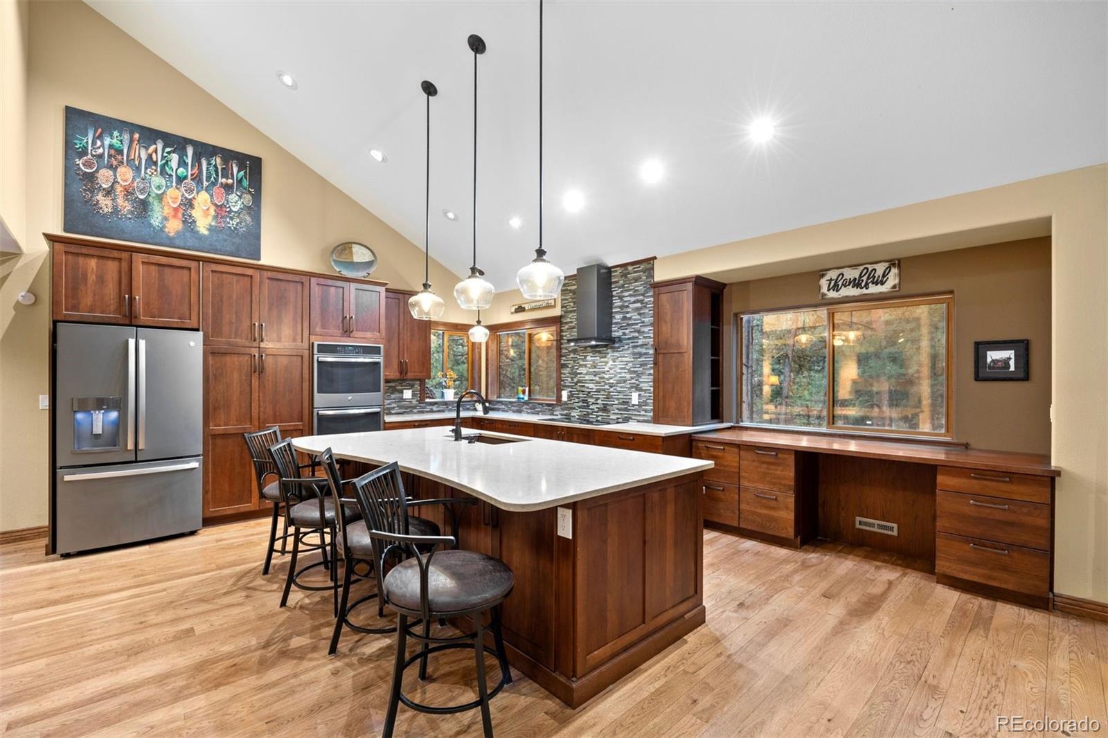 3154 South Piney Ridge Road Evergreen, CO 80439 - Photo 6 of 49 a large kitchen with a table and chairs