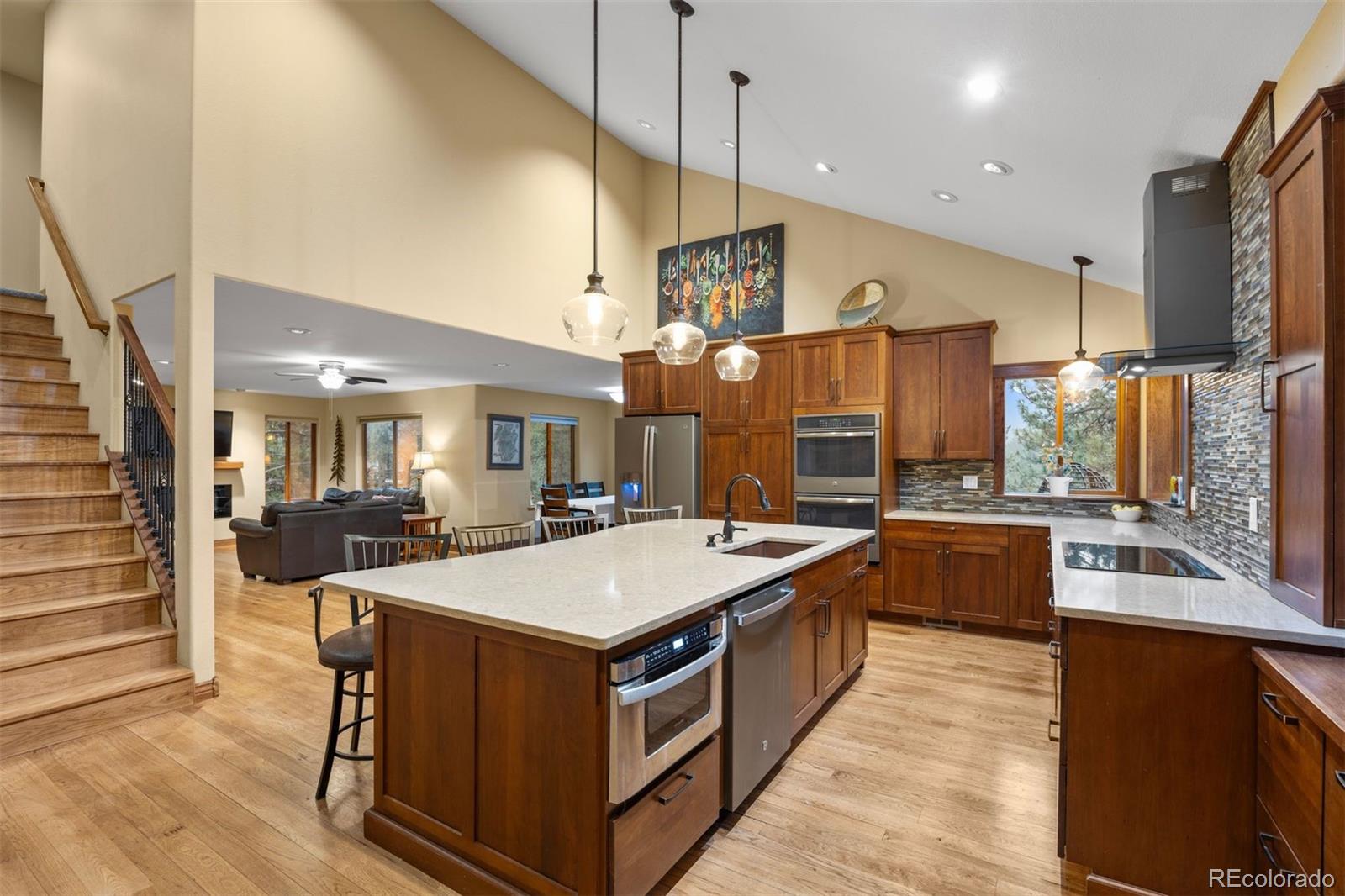 3154 South Piney Ridge Road Evergreen, CO 80439 - Photo 7 of 49 a large kitchen with kitchen island a large island in it