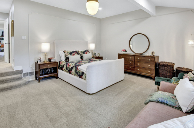 1350 Canyon Park Road Bountiful, UT 84010 - Photo 19 of 38 Spacious room featuring light-colored carpeting, a wall with decorative trim, a white upholstered headboard, and a built-in overhead light fixture