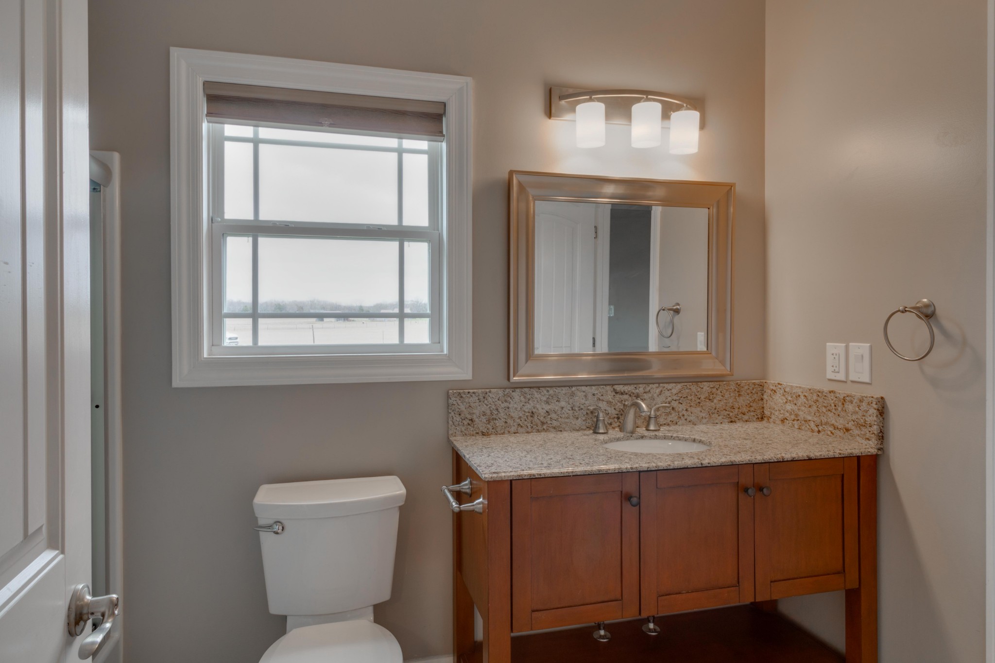3595 Clark Road Lewisburg, TN 37091 - Photo 26 of 50 a bathroom with a granite countertop toilet sink and mirror