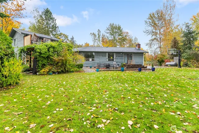 a view of a house with a yard and sitting area