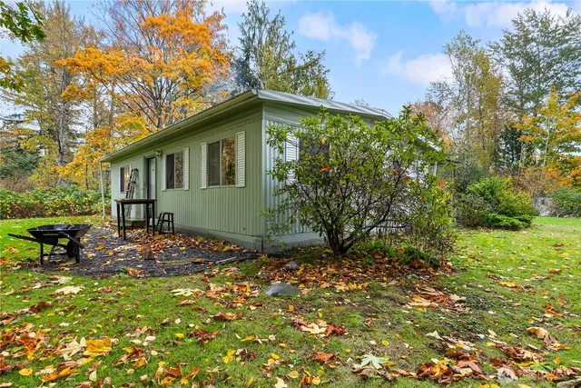 a backyard of a house with table and chairs