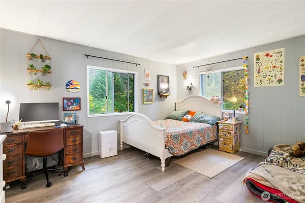 a bedroom with a bed and a desk