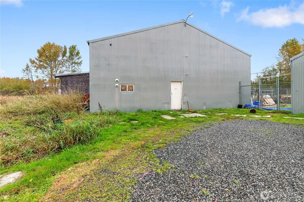 a view of a house with a yard and large tree