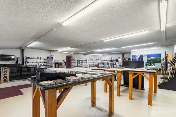 a kitchen with stainless steel appliances granite countertop a table chairs and a sink