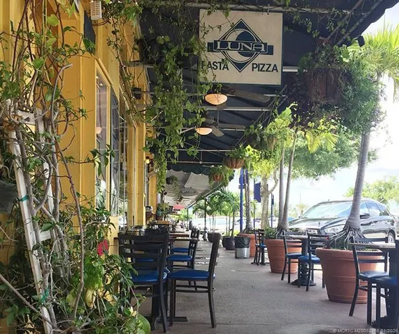 an aerial view of house with yard space and seating