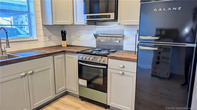 a kitchen with cabinets and appliances