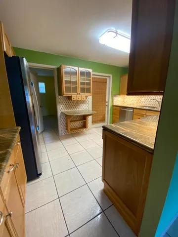 a kitchen with a sink and a refrigerator