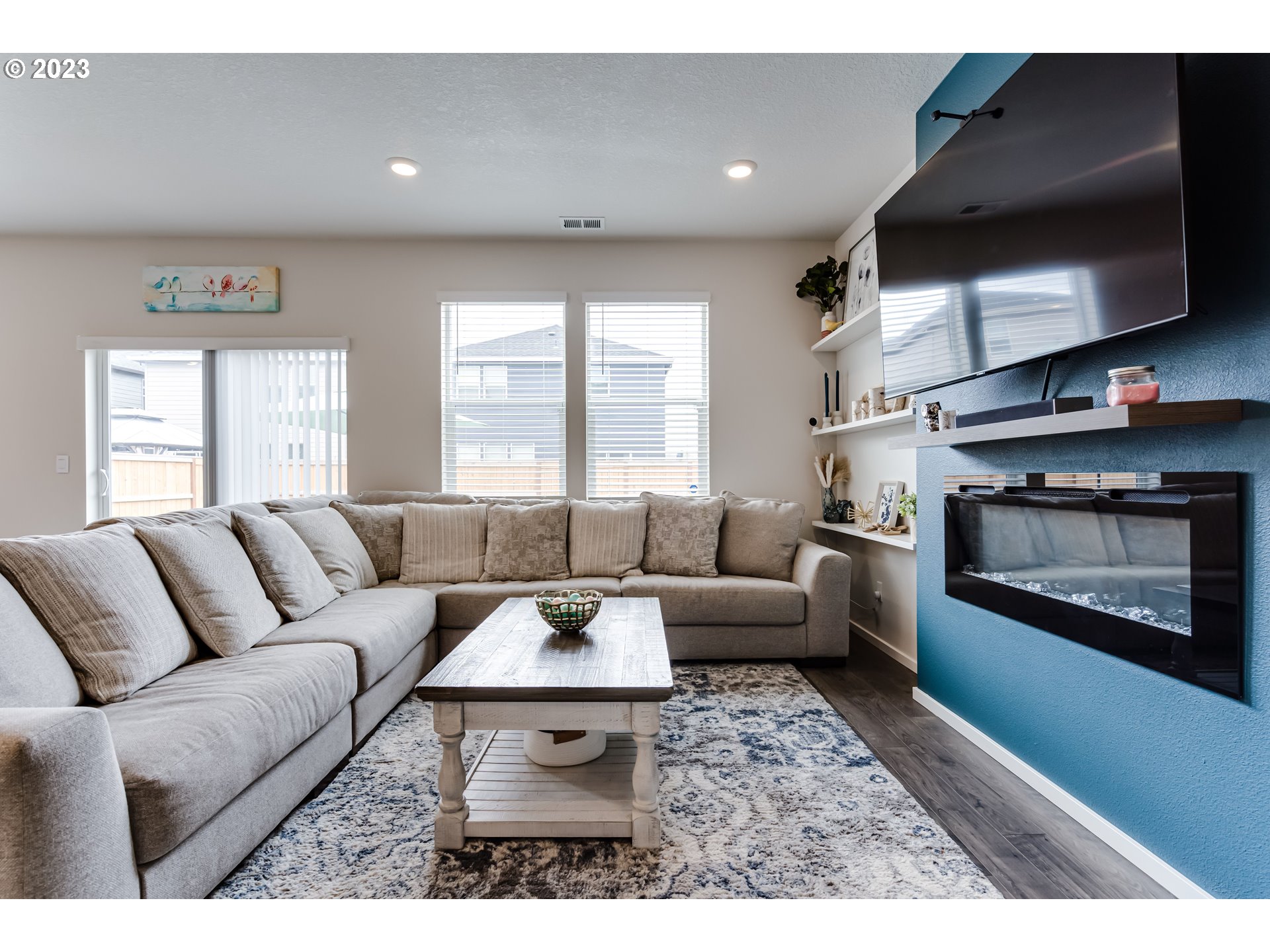 2951 Fenya Street Springfield, OR 97477 - Photo 13 of 32 a living room with furniture a flat screen tv and a fireplace