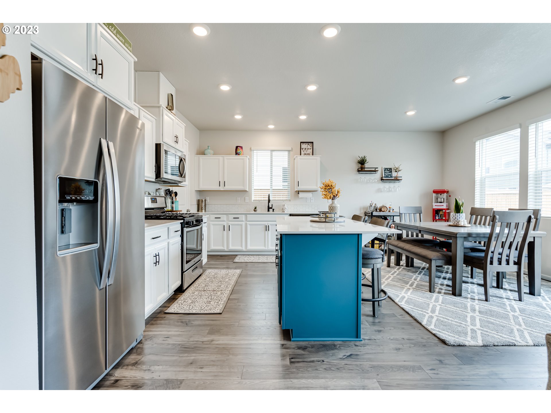 2951 Fenya Street Springfield, OR 97477 - Photo 3 of 32 a kitchen with stainless steel appliances kitchen island granite countertop a refrigerator a stove a sink a dining table and chairs