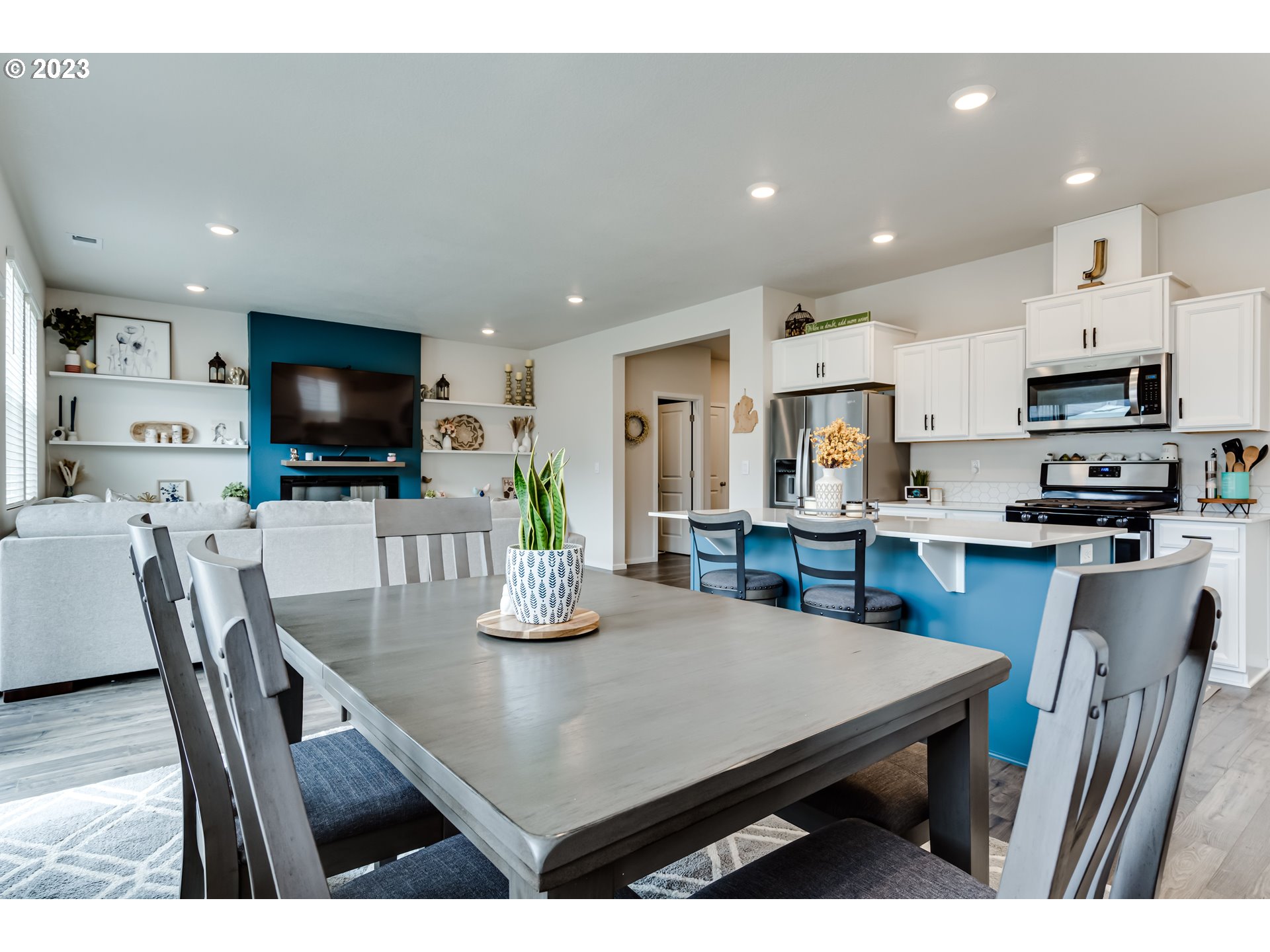 2951 Fenya Street Springfield, OR 97477 - Photo 7 of 32 a kitchen with stainless steel appliances a dining table chairs refrigerator and microwave