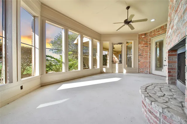 a view of a backyard with couches plants and large tree