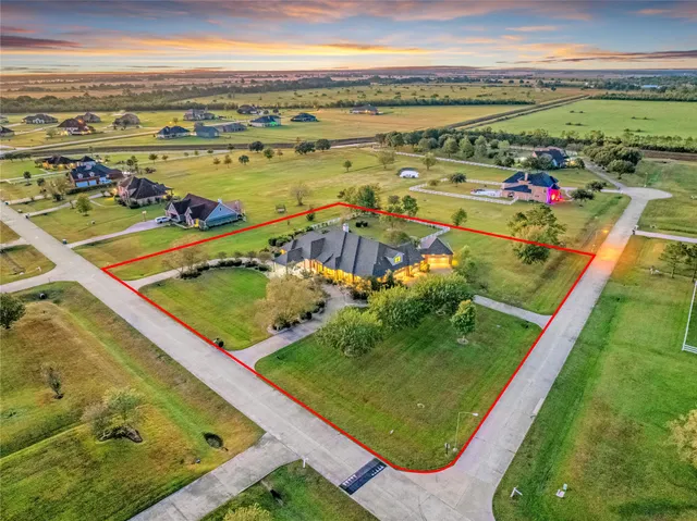 a kitchen with stainless steel appliances kitchen island granite countertop a refrigerator a stove and a sink