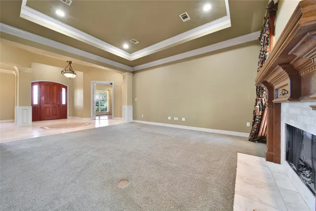 an empty room with a window and a ceiling fan