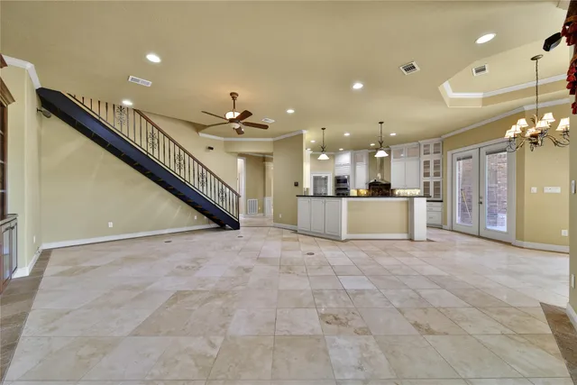 a large kitchen with granite countertop a large counter top appliances and cabinets