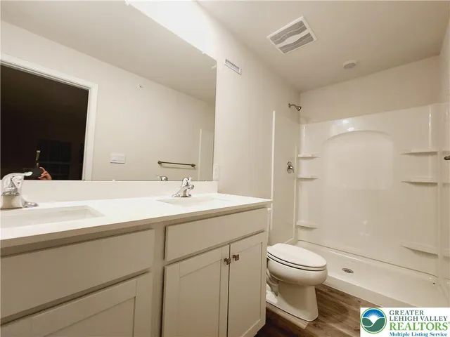 a bathroom with a sink toilet and shower