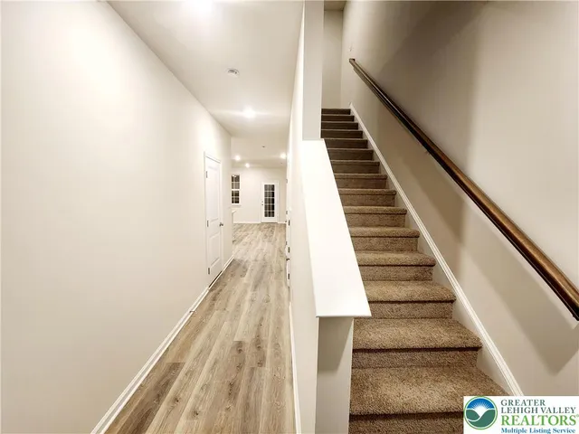a view of entryway and hall with wooden floor