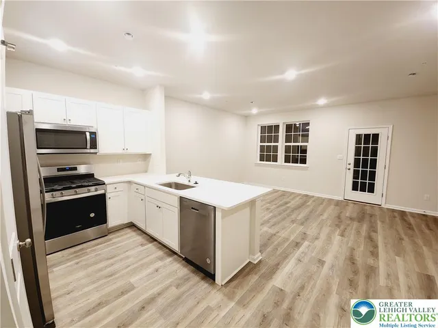 a kitchen with a stove a sink and a refrigerator
