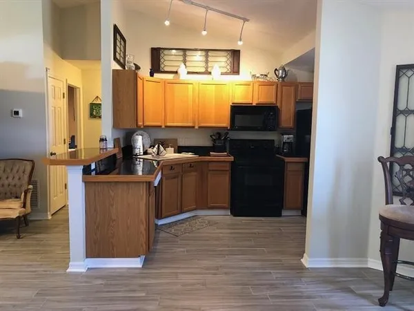 a kitchen with stainless steel appliances granite countertop a stove a refrigerator and a sink