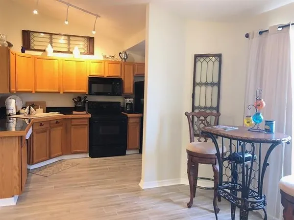 a kitchen with a table chairs and entryway