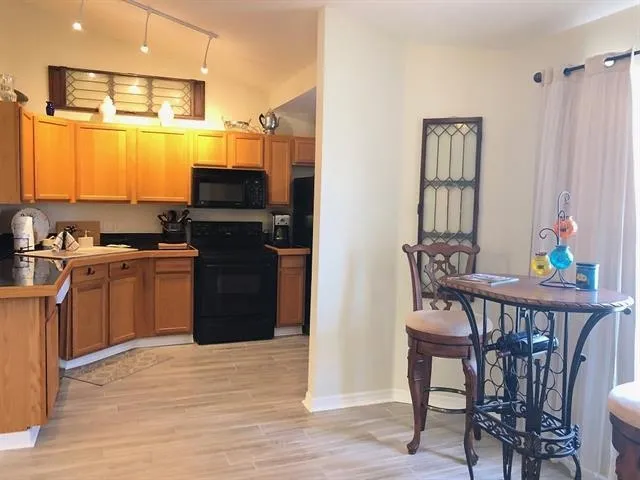 a kitchen with a table chairs and entryway