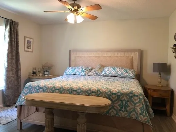 a bedroom with a bed and a chandelier