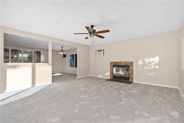 a view of a livingroom with a ceiling fan and window