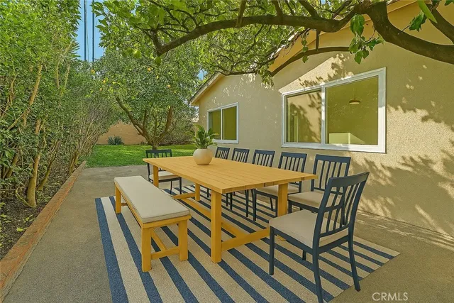 a view of a house with a tree in the background
