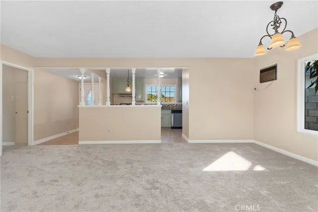 an empty room with windows and painted walls