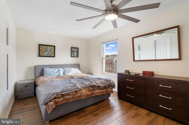 a bedroom with a bed and a painting on the wall