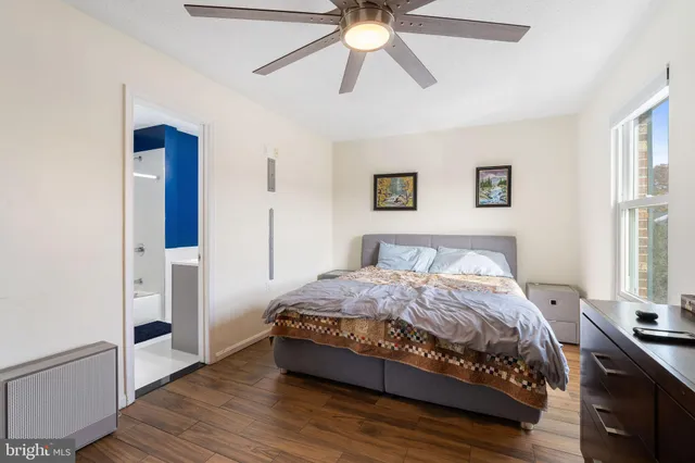 a spacious bedroom with a bed and a chandelier