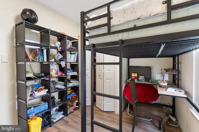 a view of a workspace with furniture and wooden floor