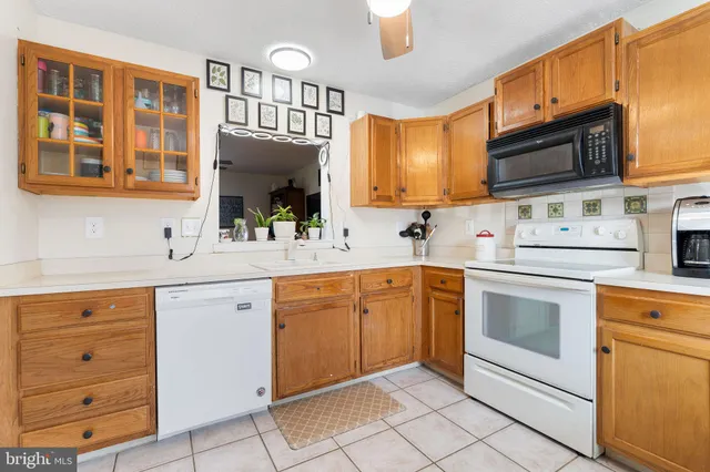 a kitchen with stainless steel appliances a stove microwave and cabinets