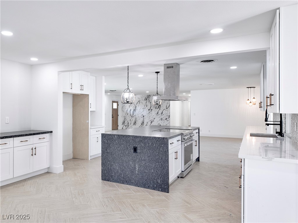 4501 South Woodcrest Road Las Vegas, NV 89121 - Photo 15 of 78 Kitchen featuring decorative light fixtures, white cabinetry, decorative backsplash, and recessed lighting