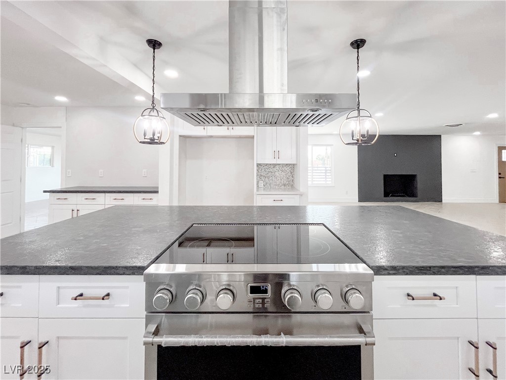 4501 South Woodcrest Road Las Vegas, NV 89121 - Photo 17 of 78 Kitchen featuring island range hood, stainless steel range, recessed lighting, white cabinets, and pendant lighting