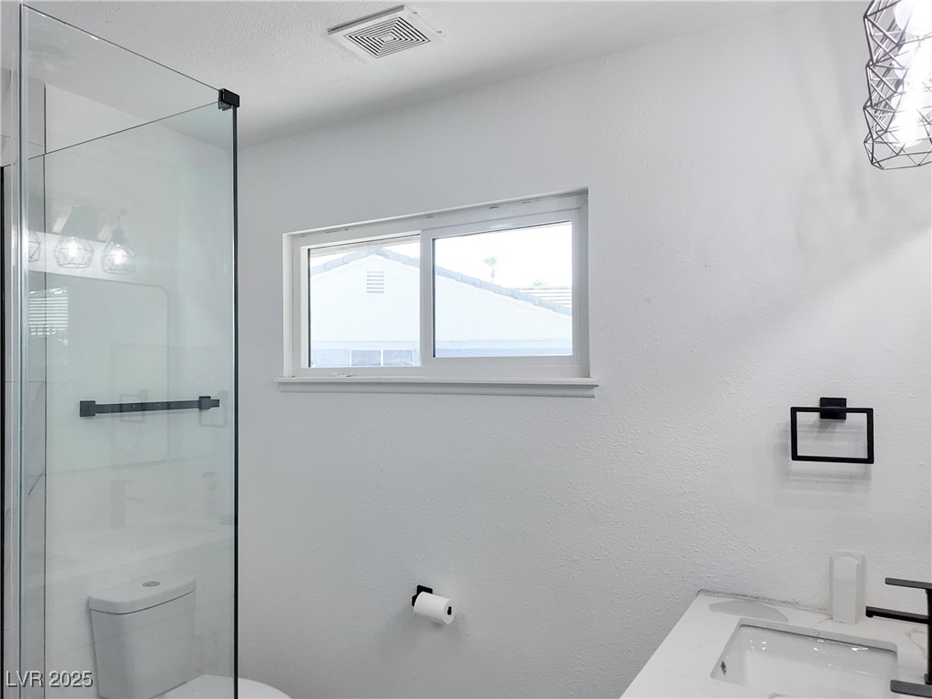 4501 South Woodcrest Road Las Vegas, NV 89121 - Photo 40 of 78 Full bath featuring a shower stall, vanity, and a textured wall