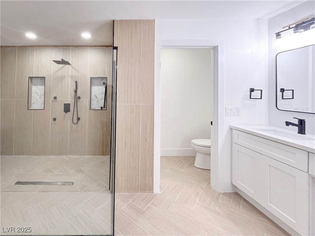 4501 South Woodcrest Road Las Vegas, NV 89121 - Photo 53 of 78 Bathroom featuring a tile shower, vanity, and recessed lighting