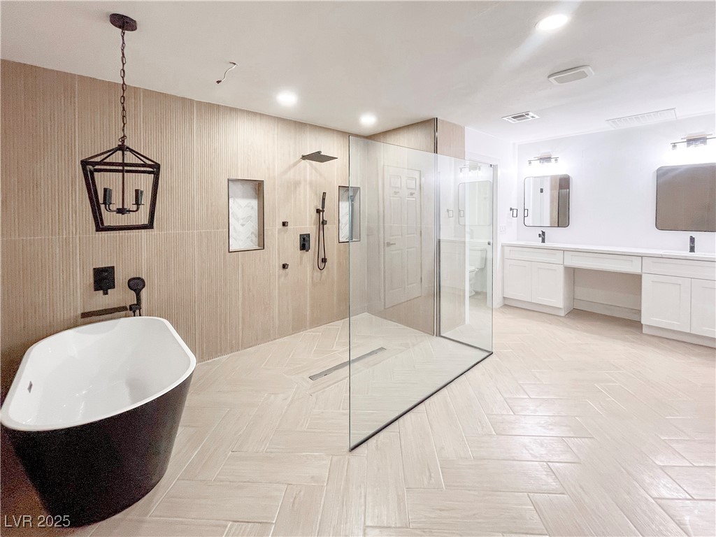 4501 South Woodcrest Road Las Vegas, NV 89121 - Photo 54 of 78 Bathroom featuring walk in shower, a freestanding tub, double vanity, and recessed lighting