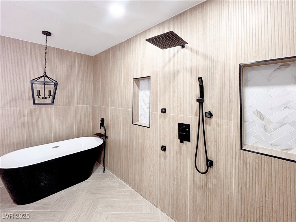 4501 South Woodcrest Road Las Vegas, NV 89121 - Photo 58 of 78 Full bath with a freestanding bath, tiled shower, and tile walls