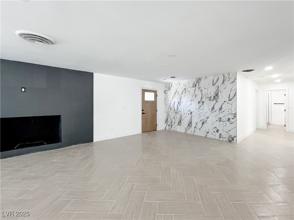 4501 South Woodcrest Road Las Vegas, NV 89121 - Photo 6 of 78 Unfurnished living room featuring baseboards