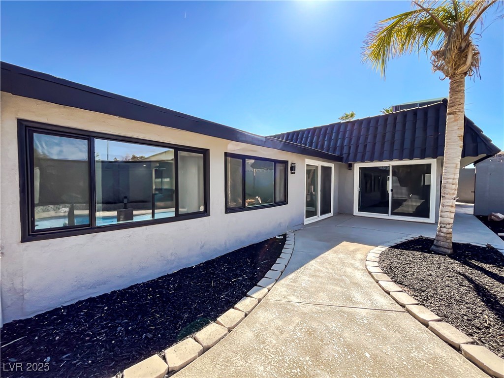 4501 South Woodcrest Road Las Vegas, NV 89121 - Photo 73 of 78 View of exterior entry with stucco siding