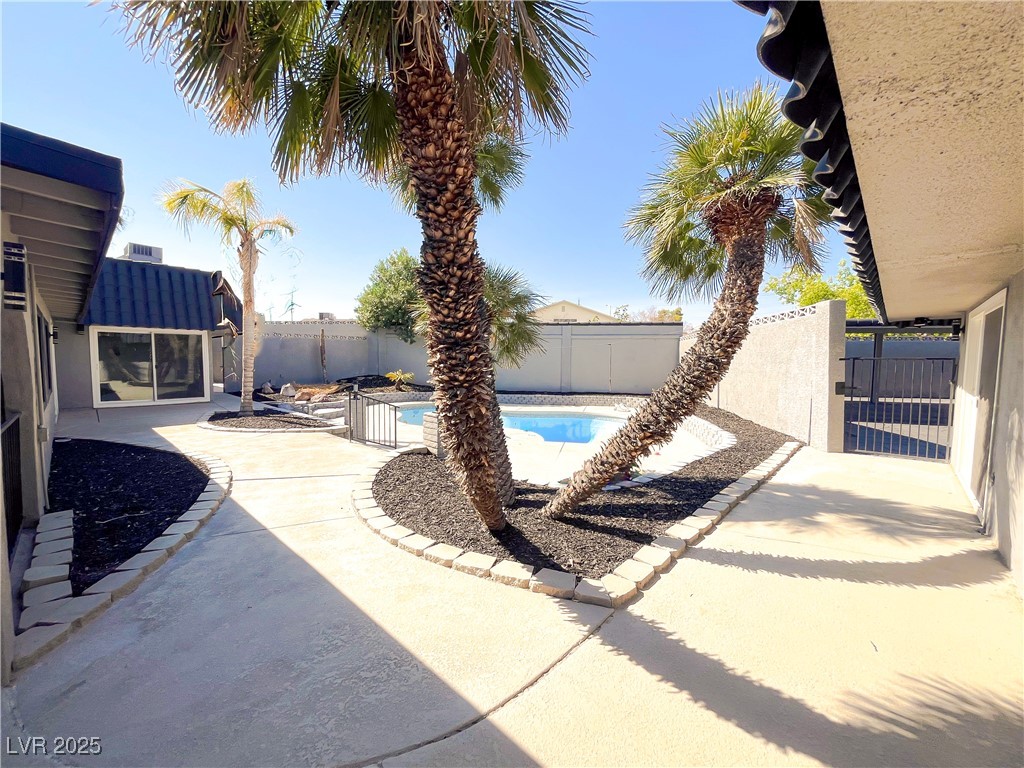 4501 South Woodcrest Road Las Vegas, NV 89121 - Photo 74 of 78 View of swimming pool featuring a patio area and a fenced backyard